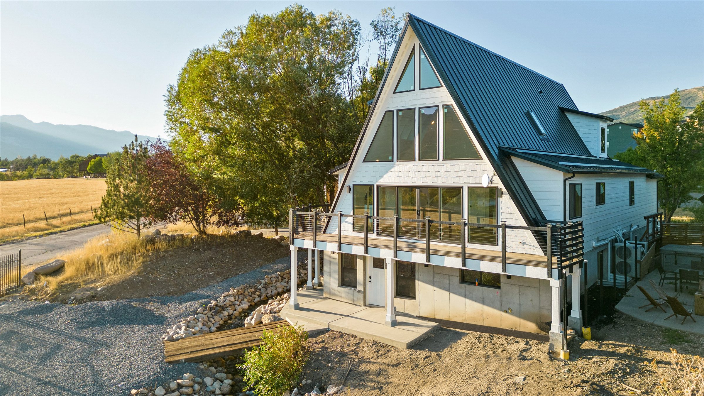 Custom Avrame A-frame mountain home at golden hour in Eden, Utah, built by Ewing Construction