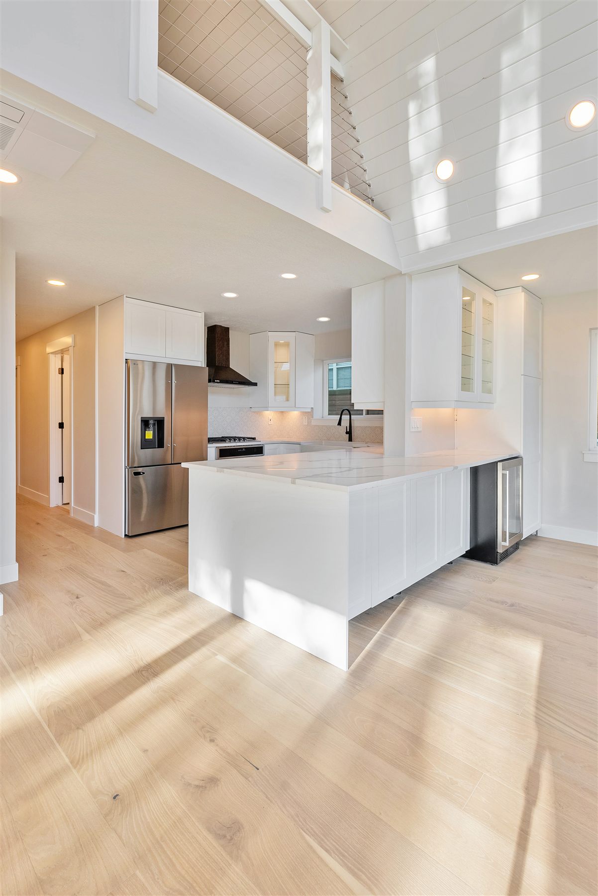 Bright open kitchen with vaulted loft in the Eden Avrame custom home